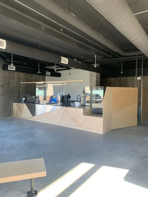 Ev charger installation in a modern interior with geometric partitions and industrial lighting