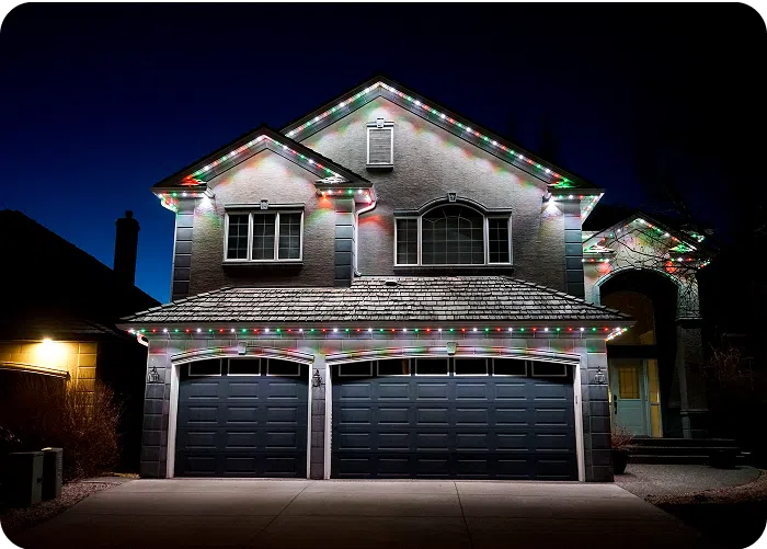 Gemstone Lights illuminate a house, creating a vibrant holiday atmosphere against a dark sky